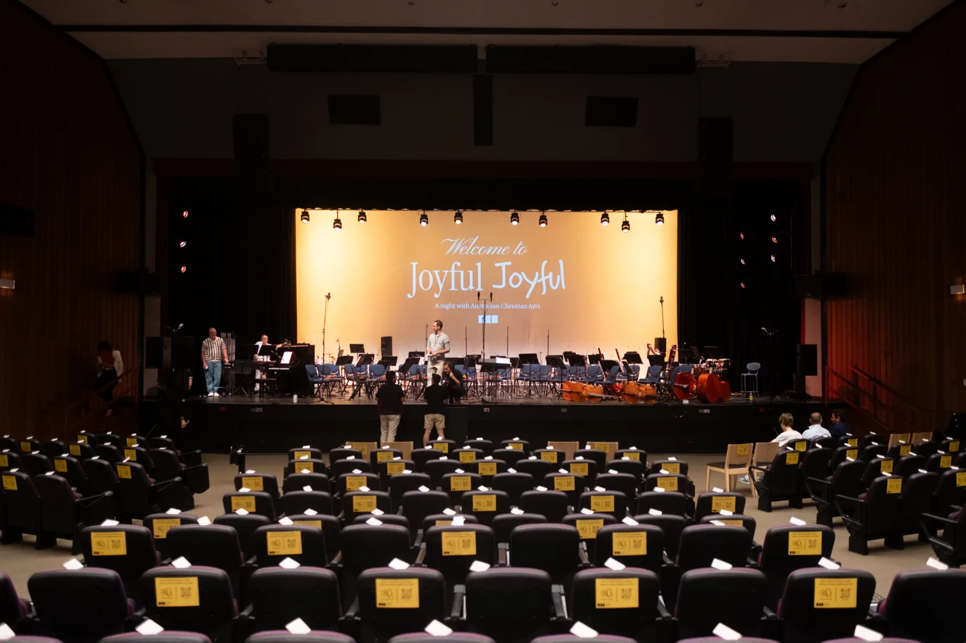Full SATB choir performing sacred choral music under concert lighting
