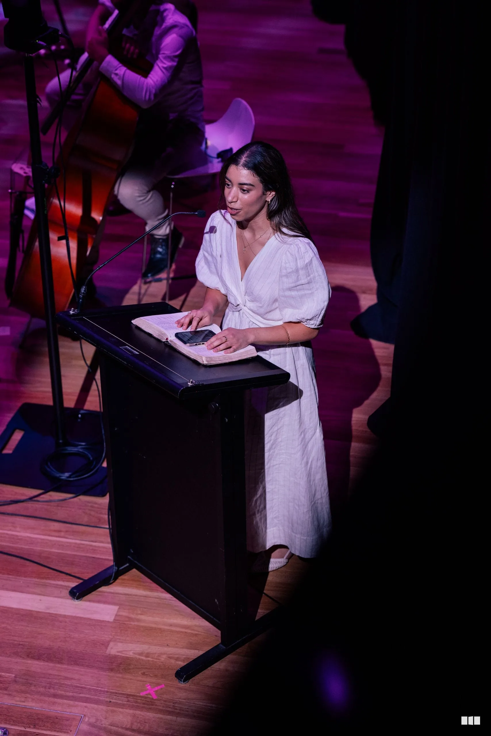 A reader delivering Scripture from the lectern during a concert
