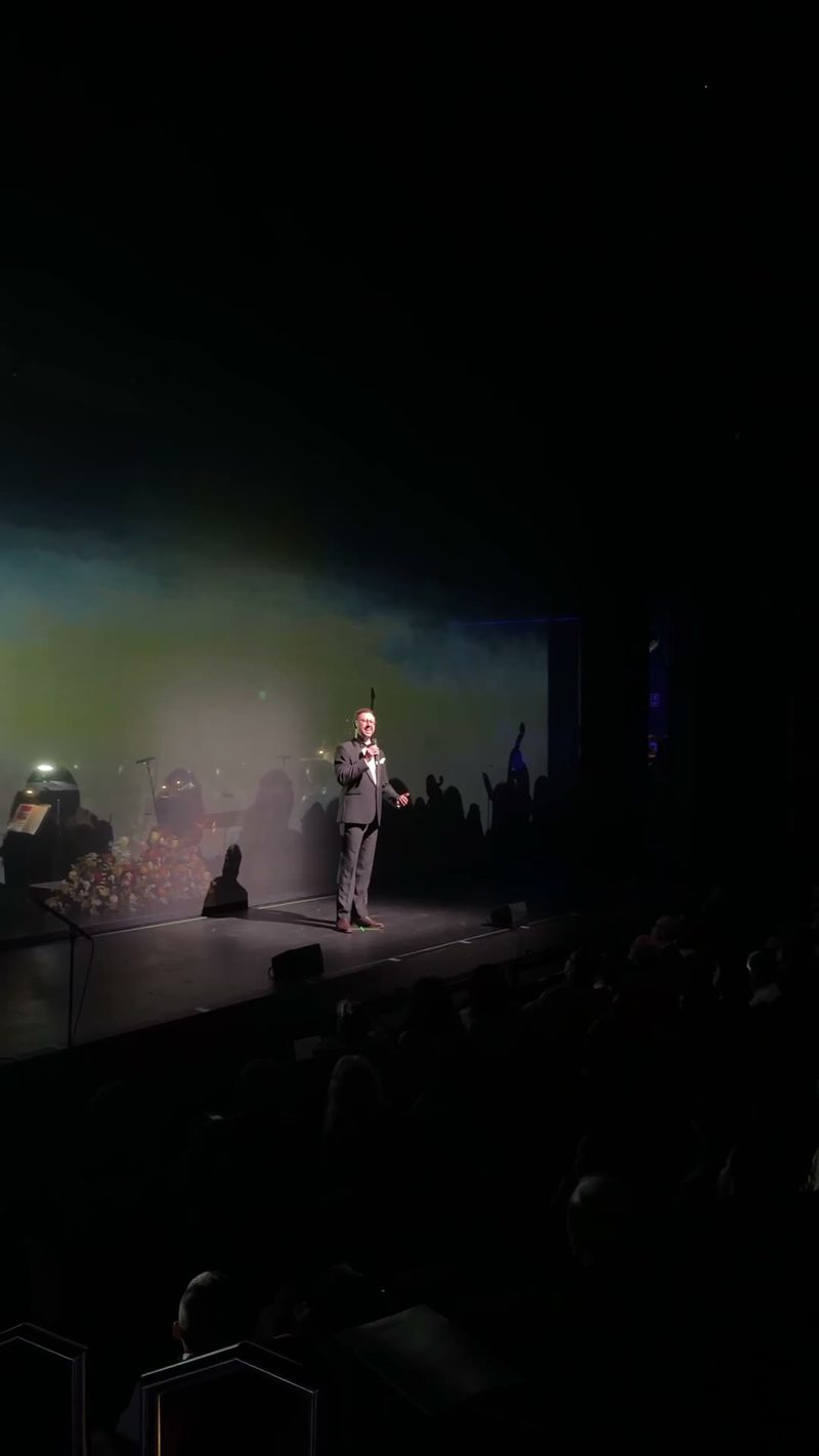A performer engaging with the audience during a concert.